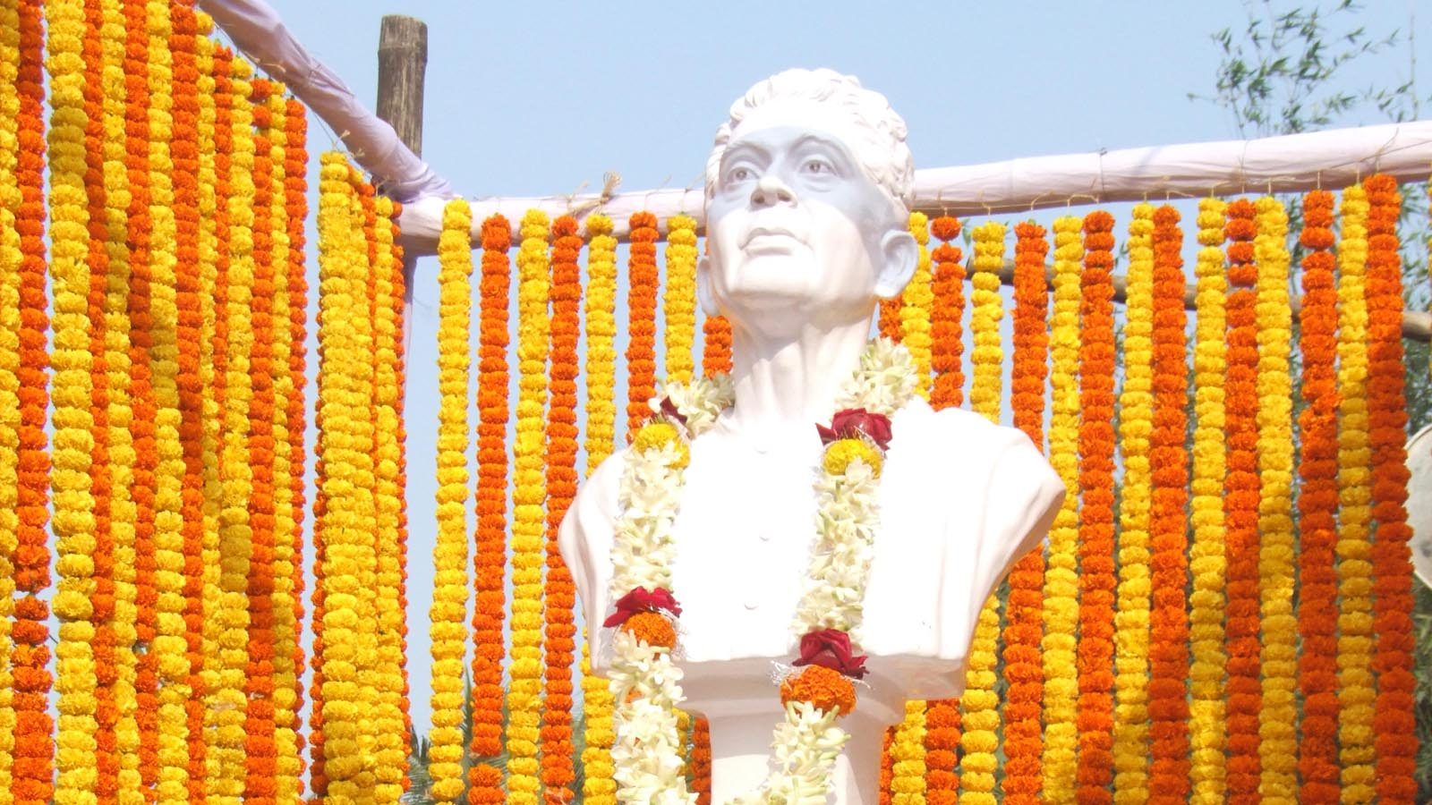 Bust of Jyotish Chandra Singha, founder of Sudpur High School, garlanded with marigolds